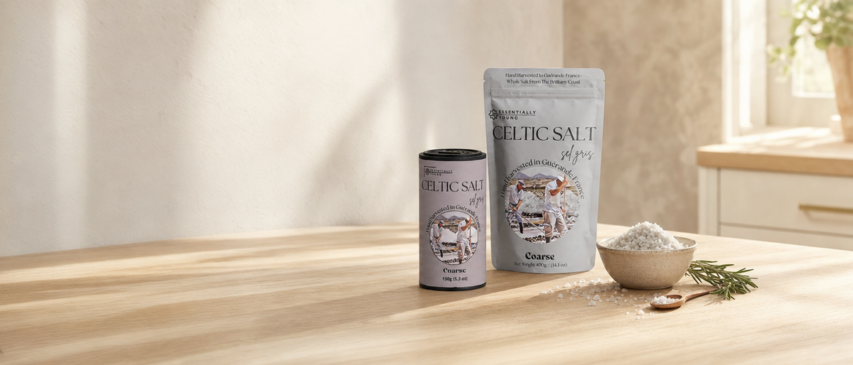 Essentially Young Celtic salt 400g pouch and 150g shaker on a sunlit oak kitchen counter with a bowl of coarse sel gris